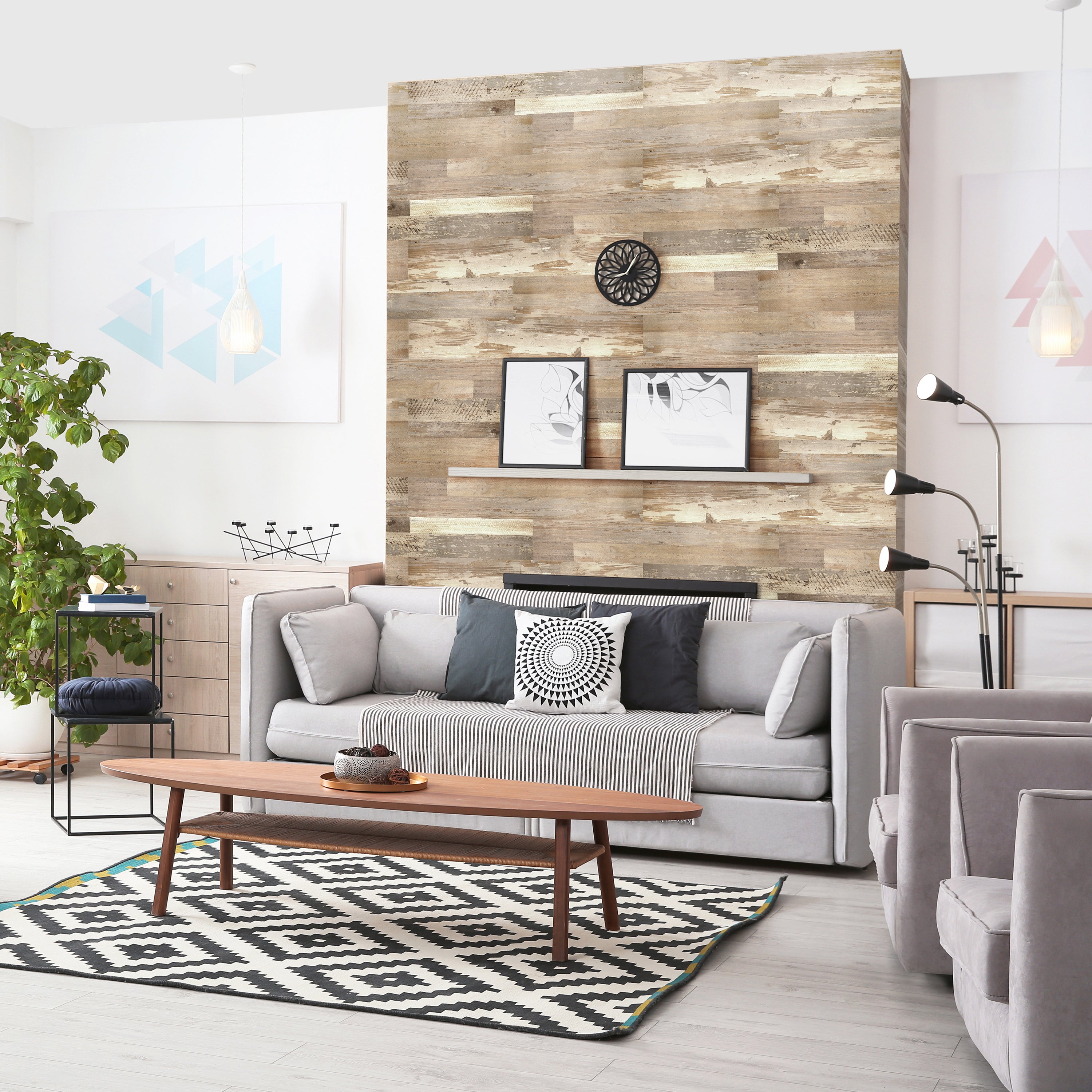 Reclaimed wood accent wall behind a living room sofa